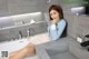 A woman sitting in a bathtub in a bathroom.