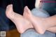 A close up of a person's feet with a tattoo on them.