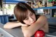 A woman leaning on a counter with her hand on her chin.