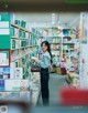 A woman standing in front of a book shelf in a bookstore.