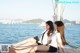 A couple of women sitting on top of a boat.